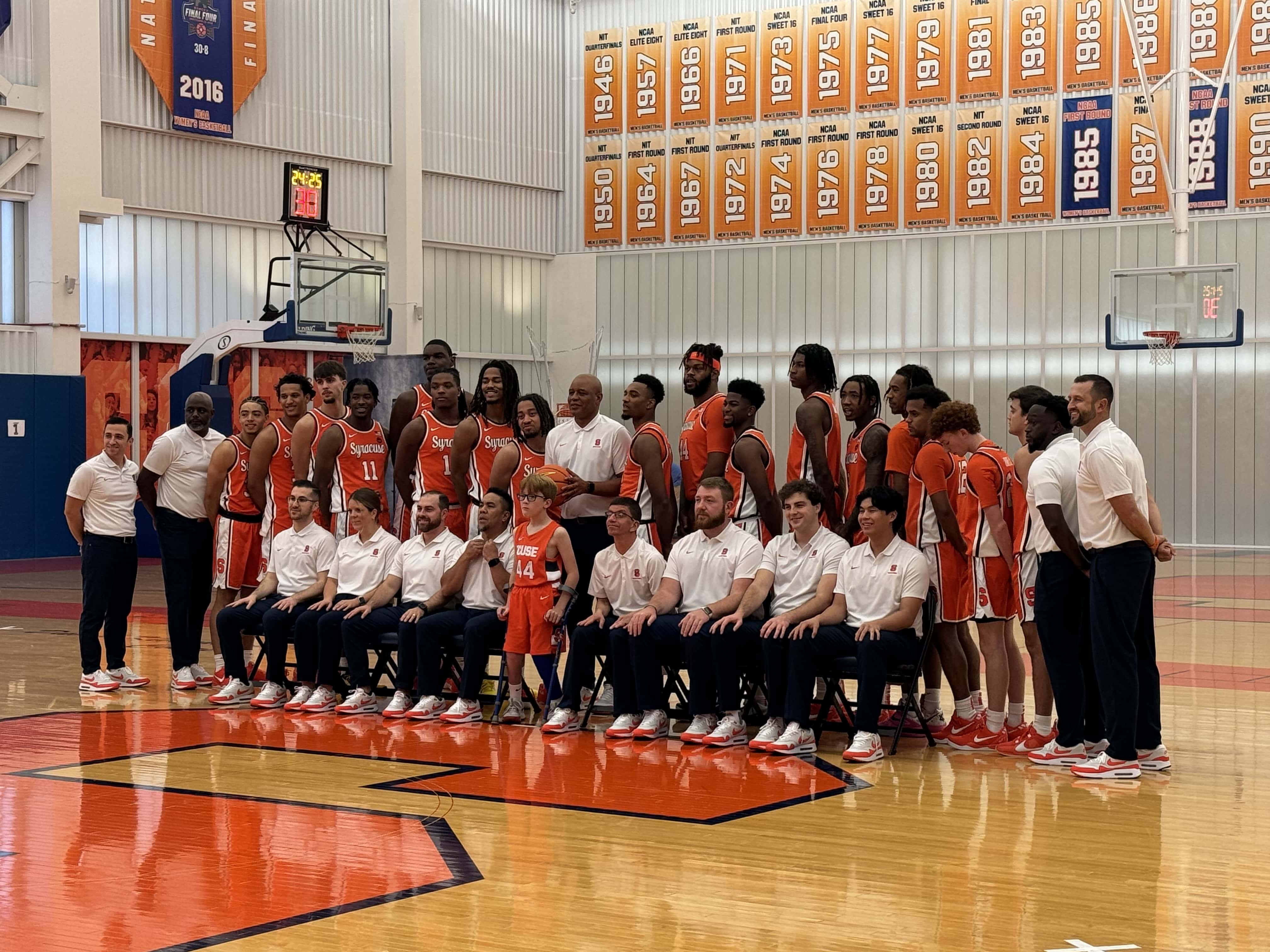 The Syracuse basketball team, setting up for a team picture at media day.