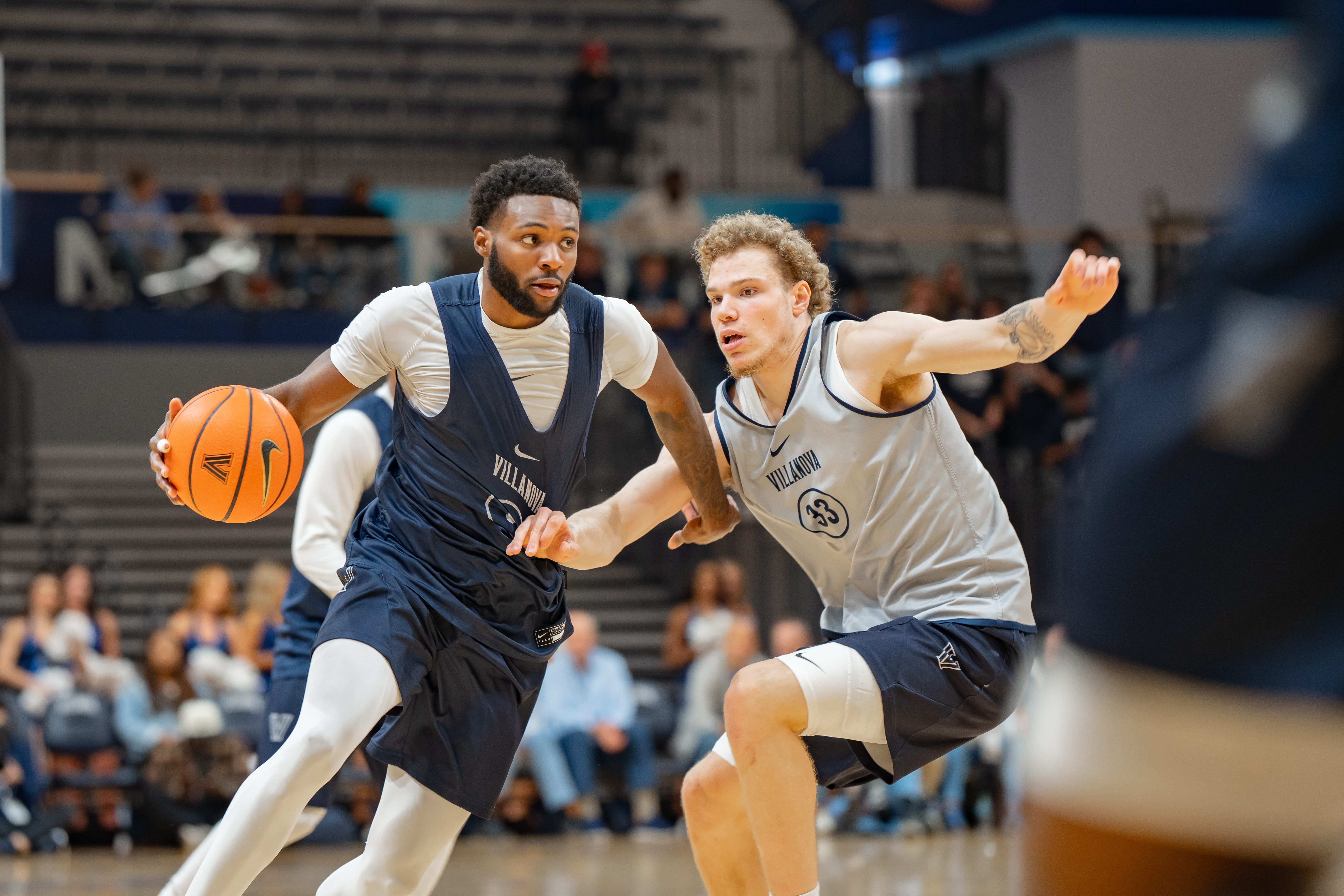 Wooga Poplar drives on Matthew Hodge during Villanova basketball's Blue-White scrimmage.