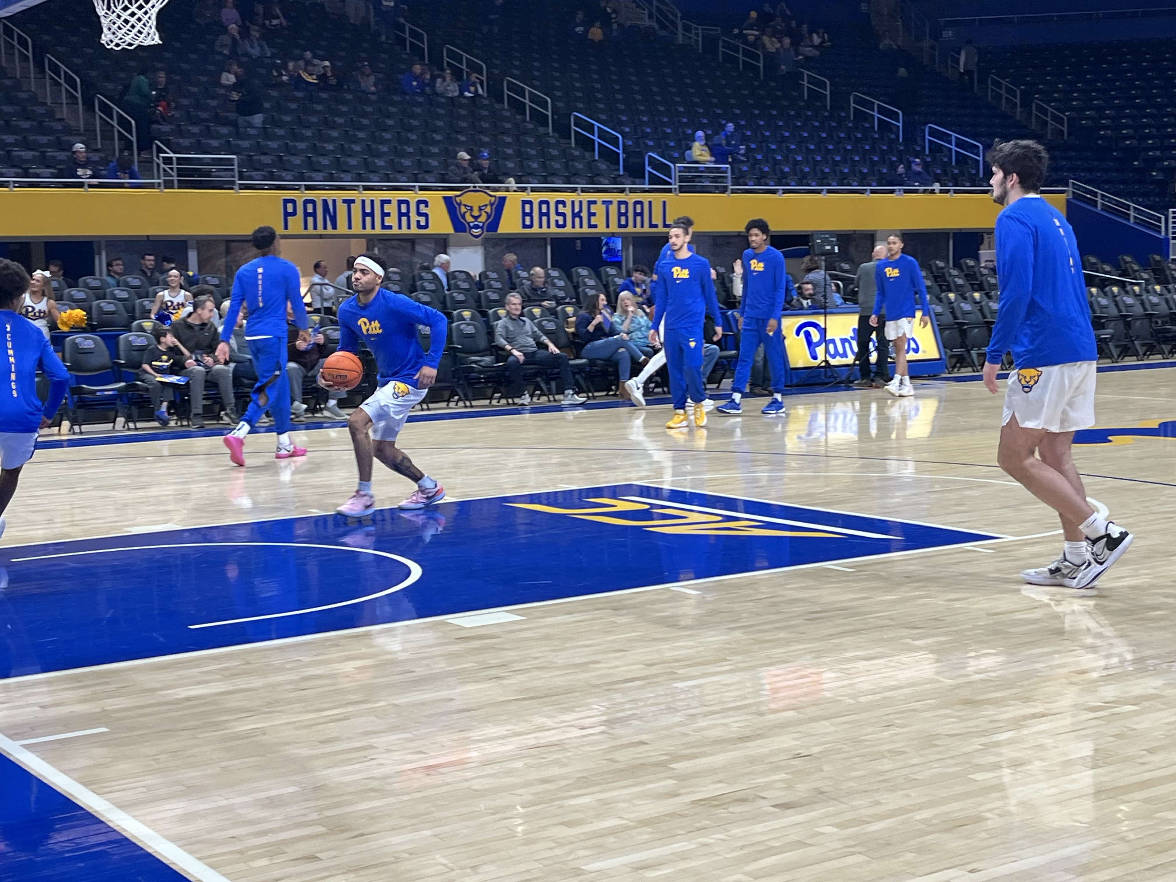 Pitt basketball star Ishmael Leggett drives toward the basket for a slam dunk in warmups.