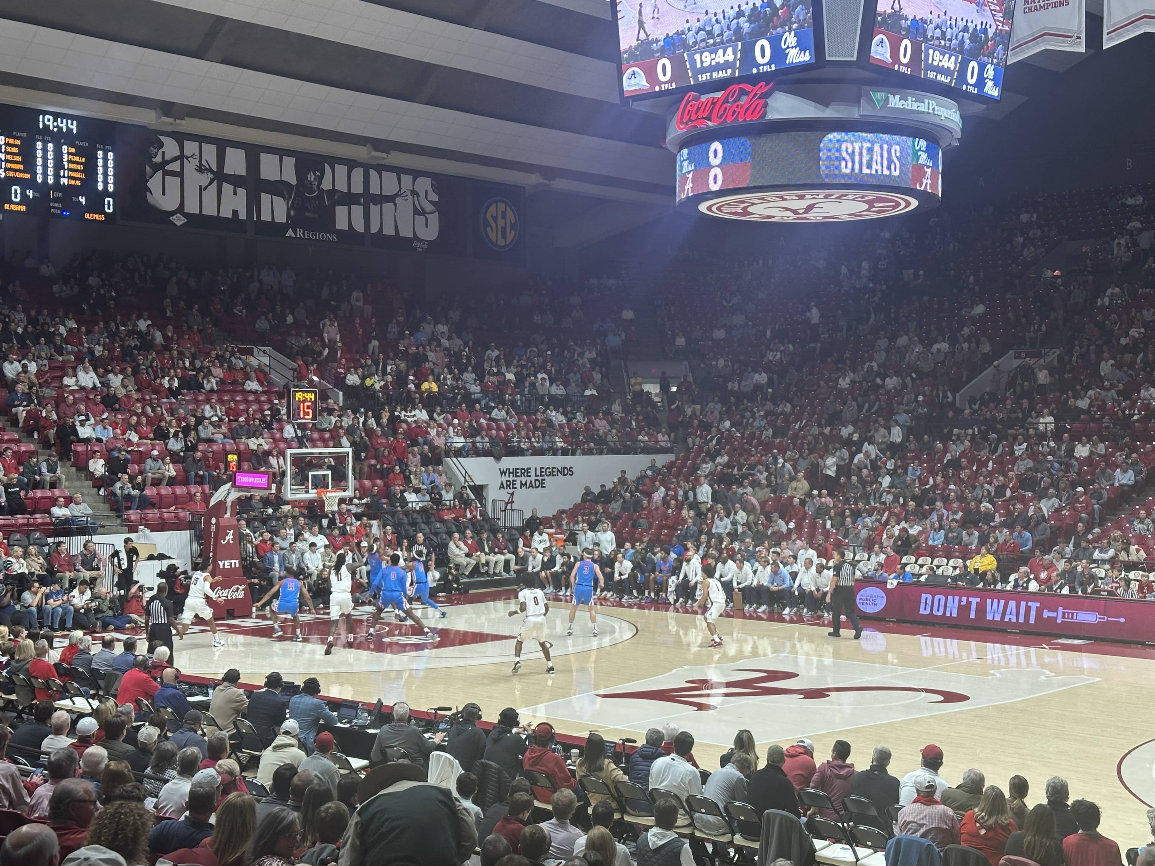 Alabama basketball's Grant Nelson trying to fend off Ole Miss defenders and get to the basket. (Photo credit: Nicholas Elliott, CBB Review)