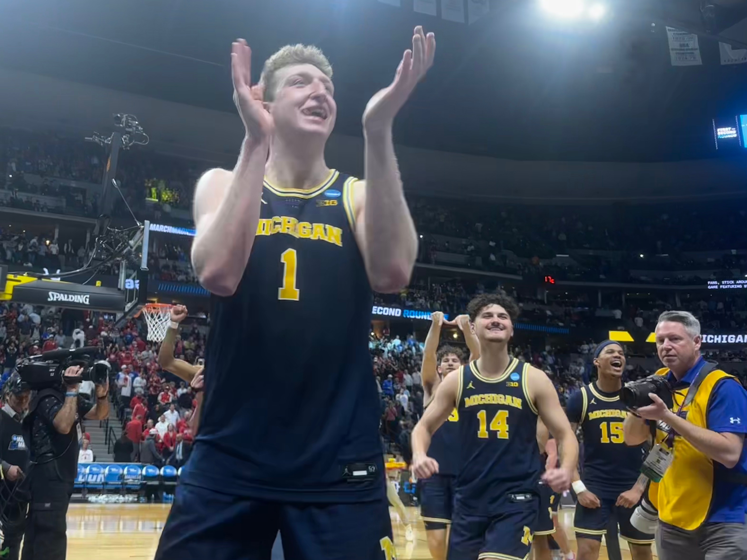 Vladislav Goldin hypes up Michigan basketball fans after securing the W in Denver.
